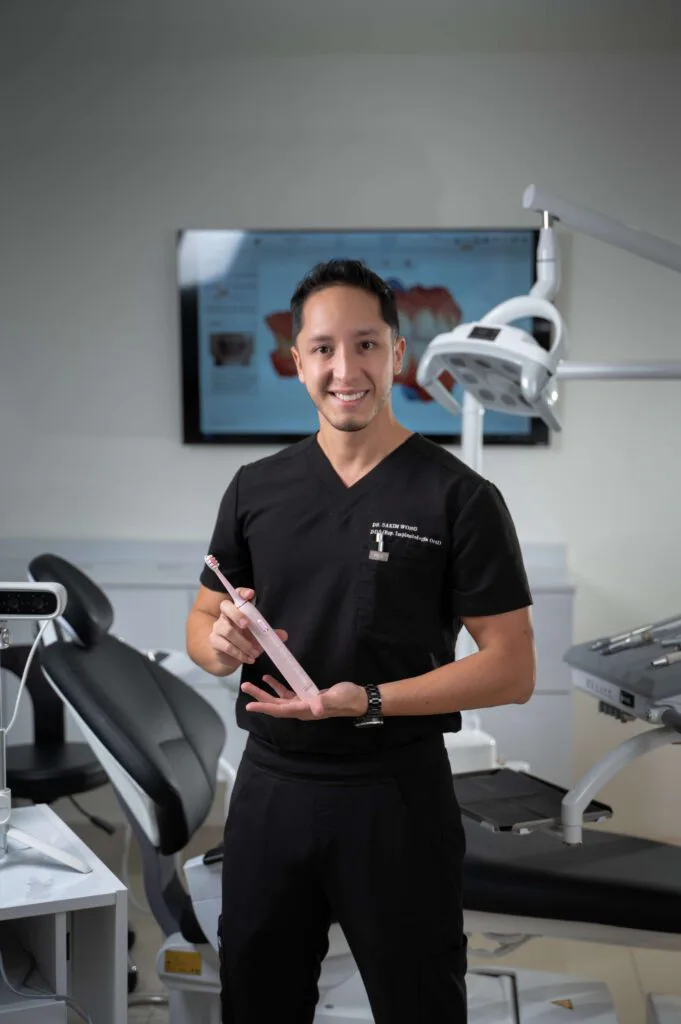 Dr. Sakim Wong holding an intraoral scanner